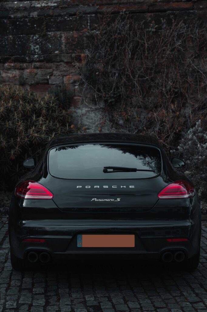black bmw car parked near brown trees during daytime