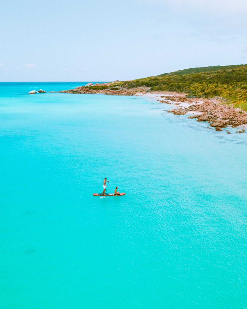 man and woman on blue kayak on blue sea water during daytime