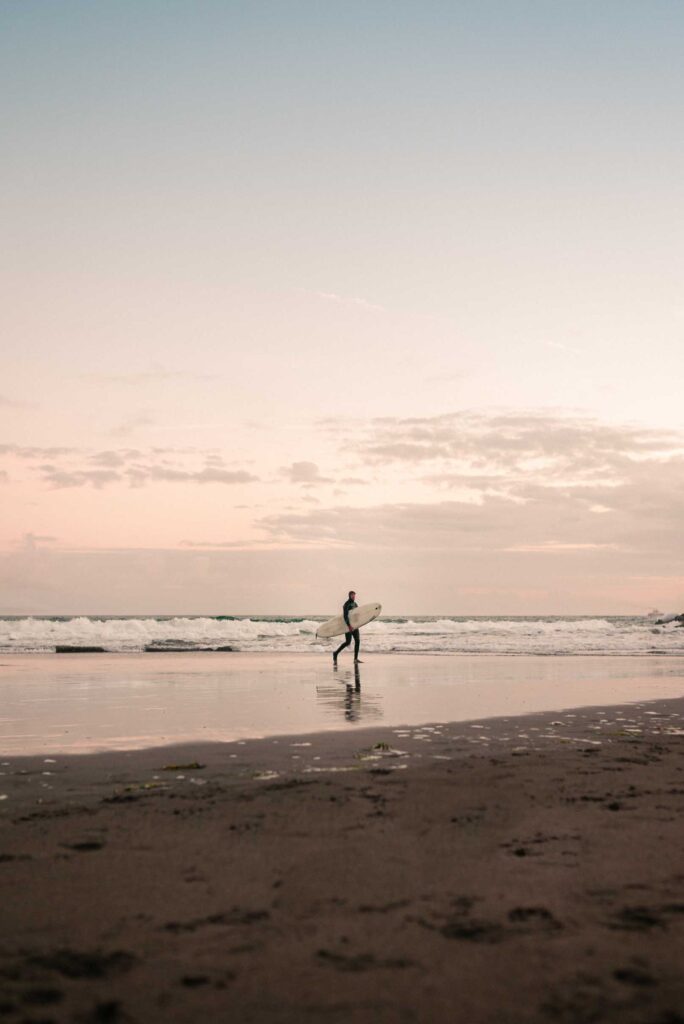silhouette of man walking on beach during daytime