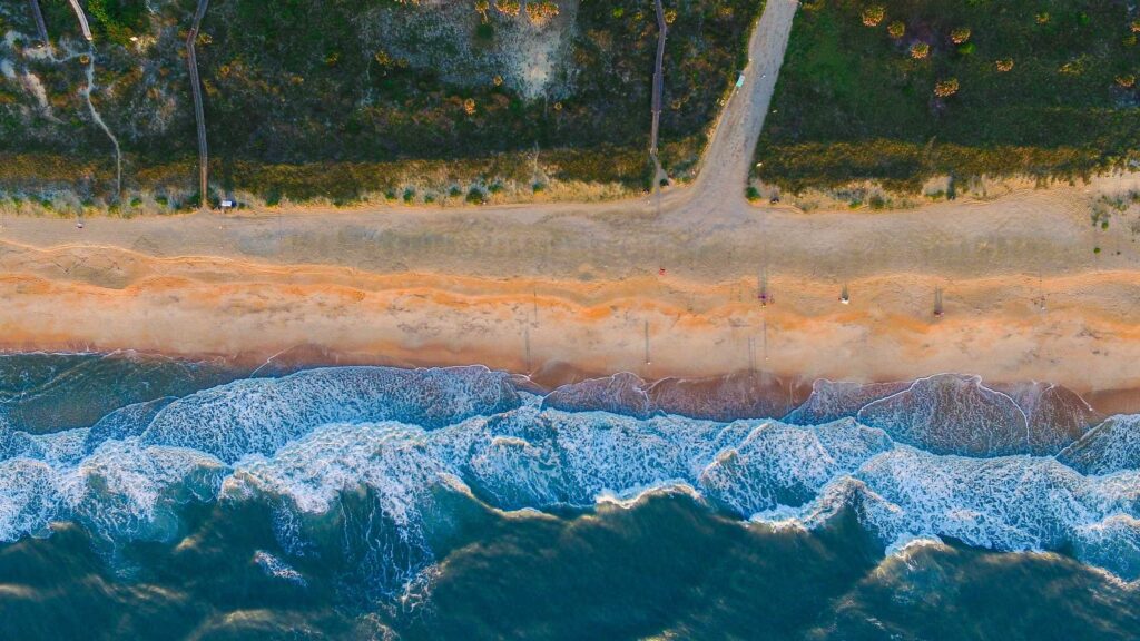 painting of sea waves and brown sandy beach