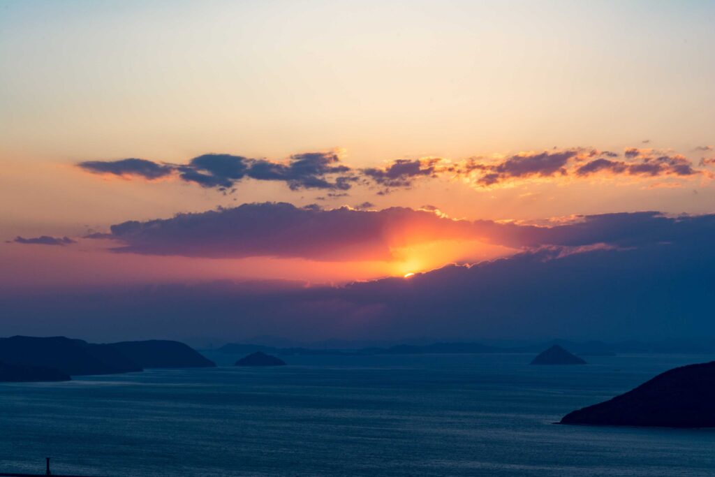 body of water under cloudy sky during sunset