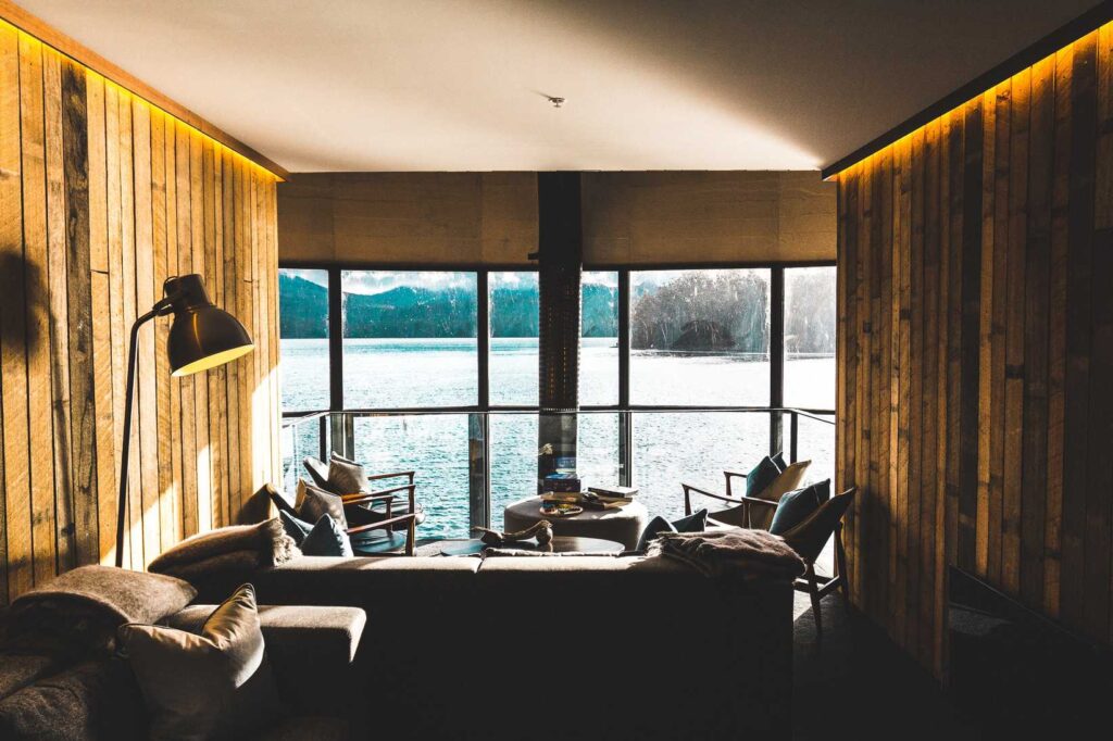 sofa and table inside room with body of water view