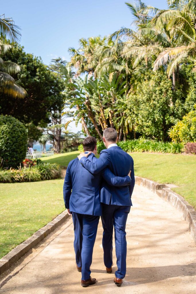 two men walking along isle leading to beach
