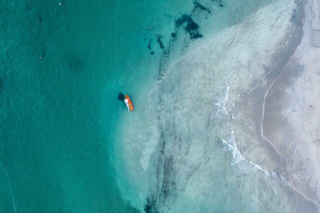 boat floating on body of water during day